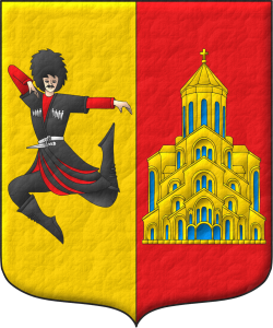 Escudo partido: 1o de oro, un bailarn georgiano al natural; 2o de gules, una iglesia de oro, aclarada de azur.